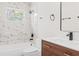 Clean bathroom with marble tile and a bathtub at 5406 Winfree Dr, Orlando, FL 32812