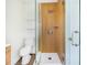 Modern bathroom with a walk-in shower and wood-look tile at 5524 Meander Dr, Lake Wales, FL 33898