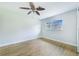 Spacious bedroom with wood-look floors and ceiling fan at 5524 Meander Dr, Lake Wales, FL 33898