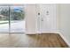 Bright entryway with wood-look floors and sliding glass door at 5524 Meander Dr, Lake Wales, FL 33898