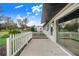 White home with a sliding glass door and a white picket fence at 5524 Meander Dr, Lake Wales, FL 33898