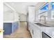 Modern kitchen with white and blue cabinets and quartz countertops at 5524 Meander Dr, Lake Wales, FL 33898