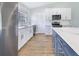 Modern kitchen with white and blue cabinets, quartz countertops, and stainless steel appliances at 5524 Meander Dr, Lake Wales, FL 33898