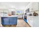 Modern kitchen with white cabinets and blue island at 5524 Meander Dr, Lake Wales, FL 33898