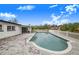 Relaxing kidney-shaped pool with a spacious patio and a white fence at 5524 Meander Dr, Lake Wales, FL 33898