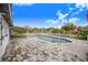 Inviting pool area with brick pavers, a covered patio, and a white picket fence at 5524 Meander Dr, Lake Wales, FL 33898