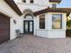 Elegant entryway with double doors and a bench at 635 Waterfern Trail Dr, Auburndale, FL 33823