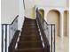 Elegant dark wood staircase with black metal railing at 635 Waterfern Trail Dr, Auburndale, FL 33823