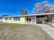 Yellow ranch home with covered entry and lawn at 703 Avenue L Se, Winter Haven, FL 33880