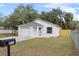 Front view of a newly built house showcasing its modern design and curb appeal at 735 Avenue R Ne, Winter Haven, FL 33881