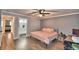 Spacious bedroom with a king-size bed, ceiling fan, and hardwood floors at 86 Winter Ridge Rd # 86, Winter Haven, FL 33881