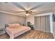 Bright bedroom with king bed, hardwood floors, and access to a patio at 86 Winter Ridge Rd # 86, Winter Haven, FL 33881