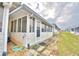 View of the back exterior of the home, showing a screened porch at 86 Winter Ridge Rd # 86, Winter Haven, FL 33881