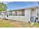 Exterior side view of the house, showing a screened porch at 86 Winter Ridge Rd # 86, Winter Haven, FL 33881