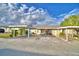 Front view of the house, showing a carport and landscaping at 86 Winter Ridge Rd # 86, Winter Haven, FL 33881