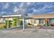 Front view of the house, showing a carport and landscaping at 86 Winter Ridge Rd # 86, Winter Haven, FL 33881