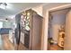 Black refrigerator and adjacent pantry with shelving and water heater at 86 Winter Ridge Rd # 86, Winter Haven, FL 33881