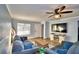 Living room with gray sofas, wood floors, and TV at 86 Winter Ridge Rd # 86, Winter Haven, FL 33881