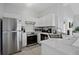 Modern kitchen featuring stainless steel appliances and white cabinetry at 938 Park Terrace Cir, Kissimmee, FL 34746