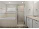 Bathroom with soaking tub, shower, and vanity at 1042 Corso Dr, Winter Haven, FL 33884