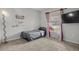 Small bedroom with a twin bed, window, and neutral decor at 1042 Corso Dr, Winter Haven, FL 33884