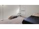 Bedroom with chaise lounge, window, and neutral decor at 1042 Corso Dr, Winter Haven, FL 33884