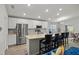 Modern kitchen with stainless steel appliances and an island with seating at 1042 Corso Dr, Winter Haven, FL 33884
