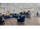 Open living room with a sectional sofa, accent chair, and kitchen island at 1042 Corso Dr, Winter Haven, FL 33884