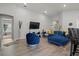 Open concept living room featuring a sectional sofa and hardwood floors at 1042 Corso Dr, Winter Haven, FL 33884
