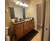 Clean bathroom with wood cabinets and a large mirror at 1068 Stoney Creek Dr, Lakeland, FL 33811