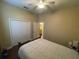 This carpeted bedroom has a closet and adjacent bathroom at 1068 Stoney Creek Dr, Lakeland, FL 33811