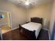 The bedroom features hardwood floors, a ceiling fan and doorway leading to the rest of the home at 1068 Stoney Creek Dr, Lakeland, FL 33811