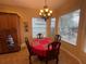 Cozy breakfast nook with a round table, four chairs, chandelier, and bright natural light at 1068 Stoney Creek Dr, Lakeland, FL 33811