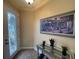 Inviting entryway with a decorative glass front door, tiled floor, console table and attractive wall art at 1068 Stoney Creek Dr, Lakeland, FL 33811