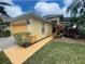Beautiful home with lush landscaping, a side walkway, and an ADT security system sign in the front yard at 1068 Stoney Creek Dr, Lakeland, FL 33811