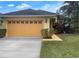 Charming single-story home featuring a well-maintained lawn, two-car garage, and colorful landscaping at 1068 Stoney Creek Dr, Lakeland, FL 33811