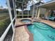 Outdoor screened-in pool and patio with hot tub and outdoor seating at 1068 Stoney Creek Dr, Lakeland, FL 33811