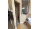 Bathroom features a walk-in shower with bronze toned tiling, a shower bar, and sliding glass window to the tub at 1068 Stoney Creek Dr, Lakeland, FL 33811