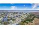 Aerial view showcasing home's waterfront lot and surrounding neighborhood at 13901 Hatchineha Rd, Haines City, FL 33844