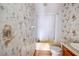 Bathroom with shower/tub combo, toilet and patterned wallpaper at 13901 Hatchineha Rd, Haines City, FL 33844