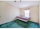 Small bedroom with a twin-size bed and green carpet at 13901 Hatchineha Rd, Haines City, FL 33844