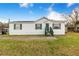 Front view of the home, showcasing the green door and yard at 13901 Hatchineha Rd, Haines City, FL 33844
