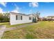 Side view of the home, showcasing its white exterior and green trim at 13901 Hatchineha Rd, Haines City, FL 33844