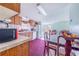 Cozy kitchen features wood cabinets, and a view into the dining area at 13901 Hatchineha Rd, Haines City, FL 33844