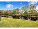 Waterfront property with a dock and lush landscaping at 13901 Hatchineha Rd, Haines City, FL 33844