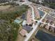 Aerial view of community with pool, tennis court, and lake nearby at 1649 Linz Ct, Winter Haven, FL 33884