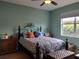 Bedroom with teal walls, metal bed frame, and wood nightstand at 1649 Linz Ct, Winter Haven, FL 33884