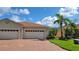 Charming single-story home with a three-car garage, paver driveway, and lush landscaping at 1649 Linz Ct, Winter Haven, FL 33884