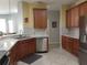 Kitchen with wood cabinets, granite countertops, and stainless steel appliances at 1649 Linz Ct, Winter Haven, FL 33884
