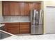 Kitchen with stainless steel refrigerator and wood cabinets at 1649 Linz Ct, Winter Haven, FL 33884